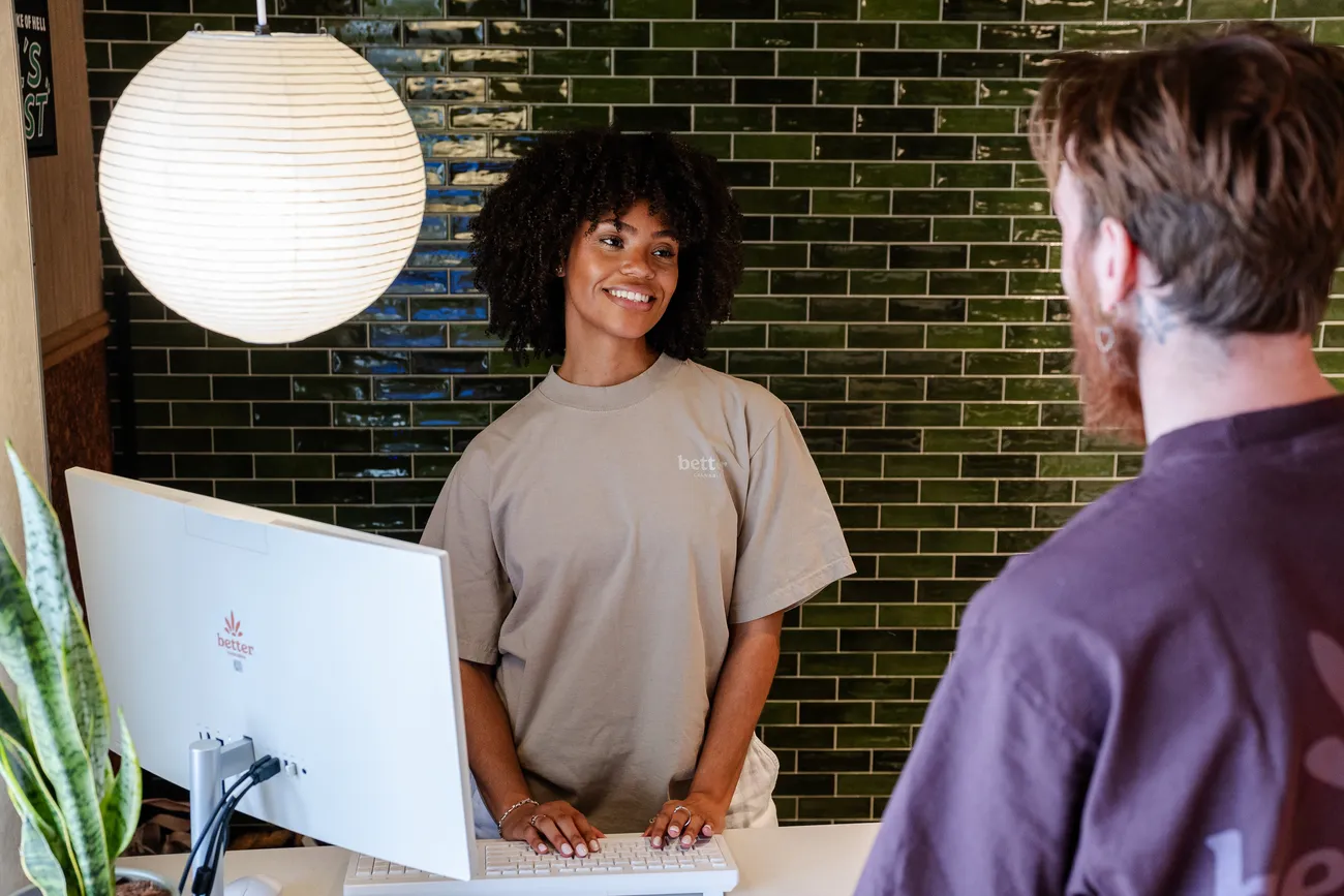 A Better Cannabis budtender guiding a customer at the in-store counter in Detroit